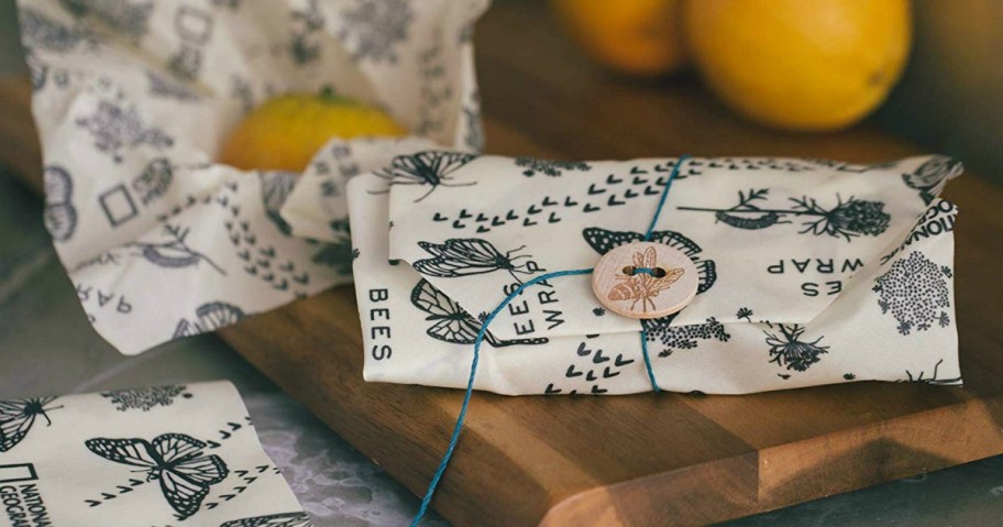 bees wraps with wood button and tie on wood cutting board