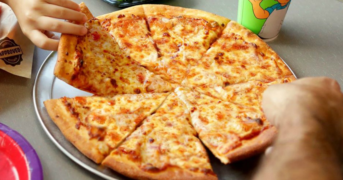 hands reaching for a slice of pizza