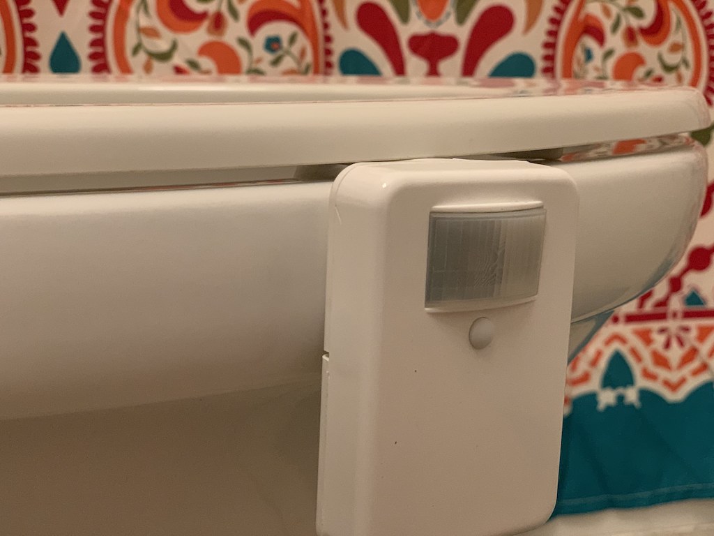 close up of motion light attached to toilet seat