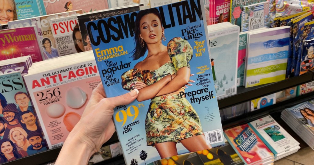 woman hand holding cosmopolitan magazine