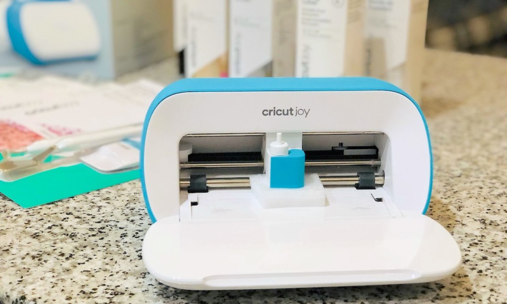 bright blue and white printer sitting on granite countertop