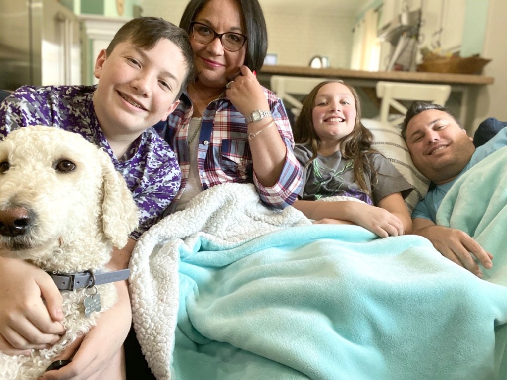 family on the couch with dog