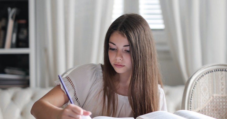 girl doing homework and kids worksheets