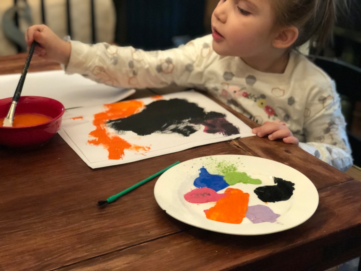 girl painting at table