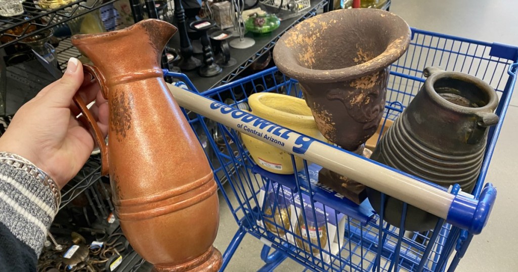 goodwill pottery pieces in a shopping cart