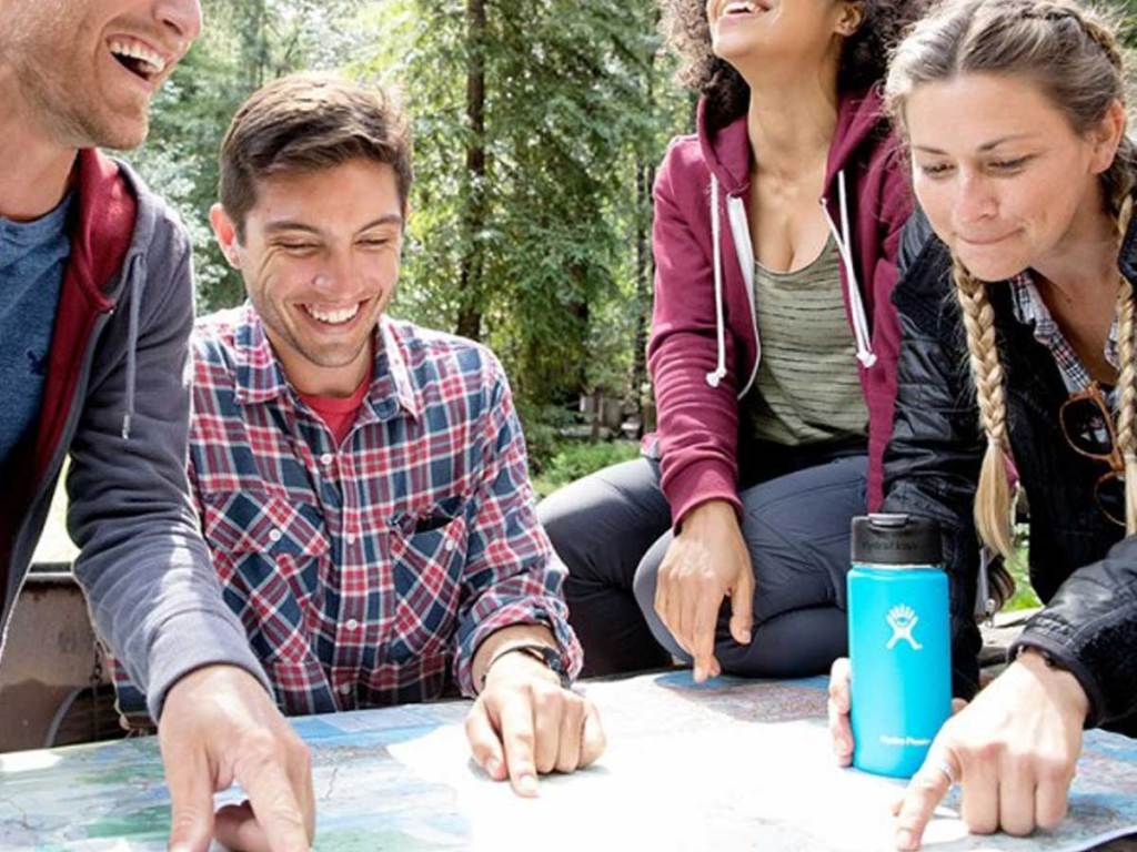 people sitting around laughing around a hydro flask coffee flask