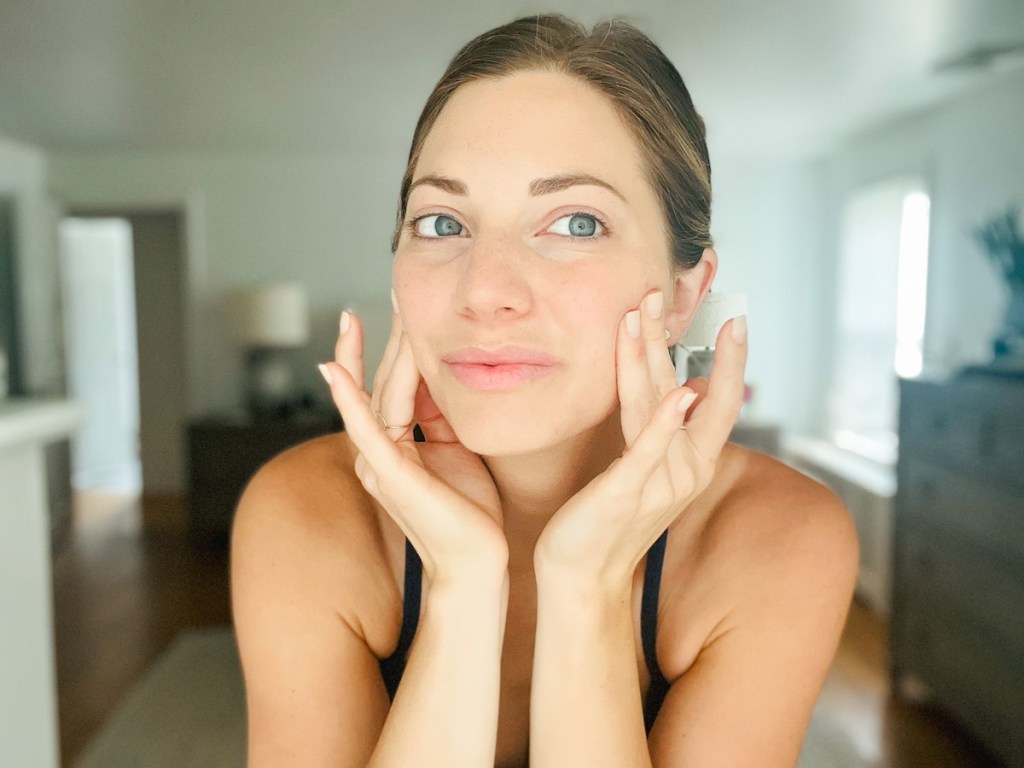 close up of woman massaging side of face