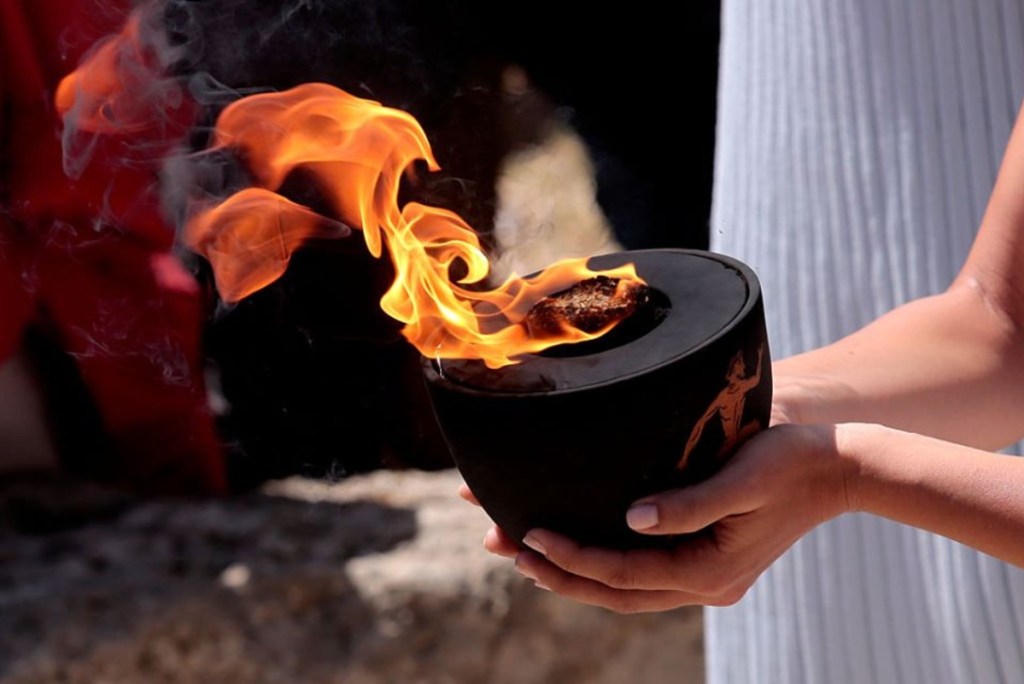 hands holding Olympic flame