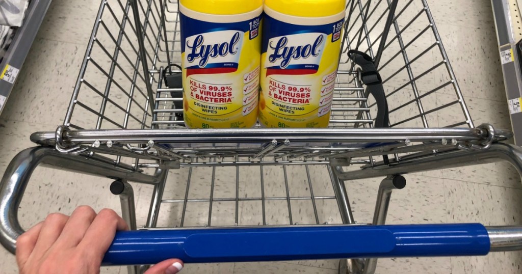 pushing Walgreens cart with Lysol wipes inside 
