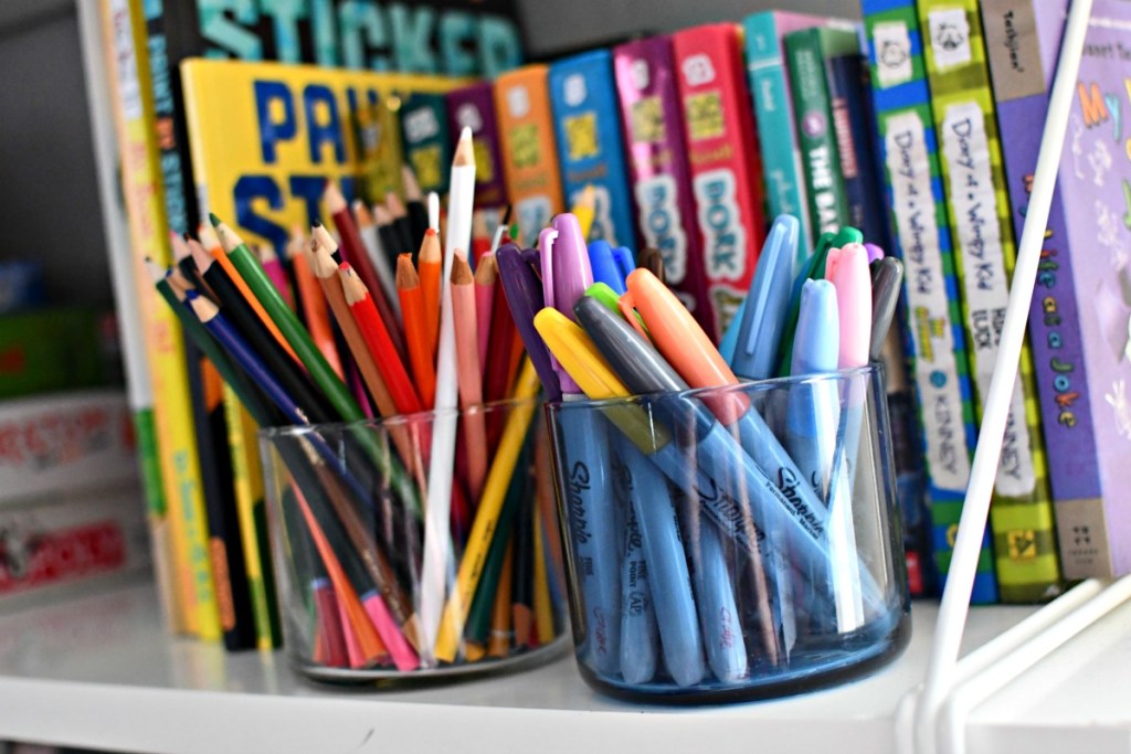 storing markers and pencils in candle jars
