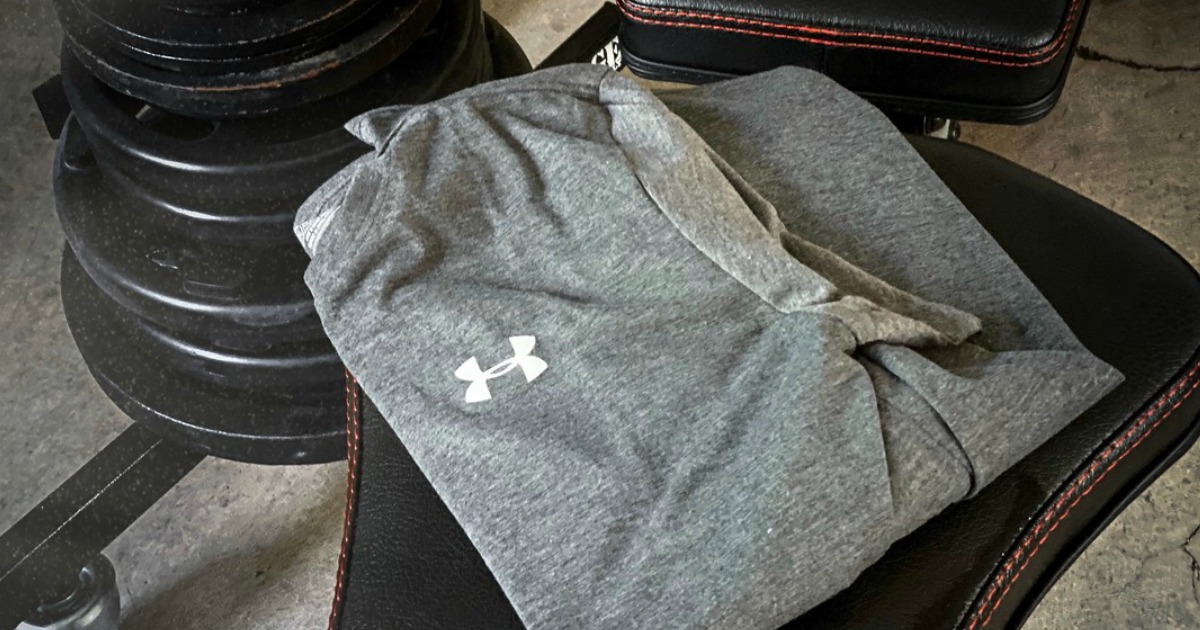 shirt folded on workout bench in weight room