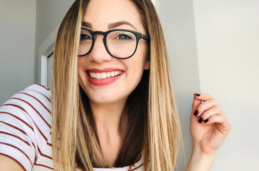 close up of woman wearing warby parker glasses