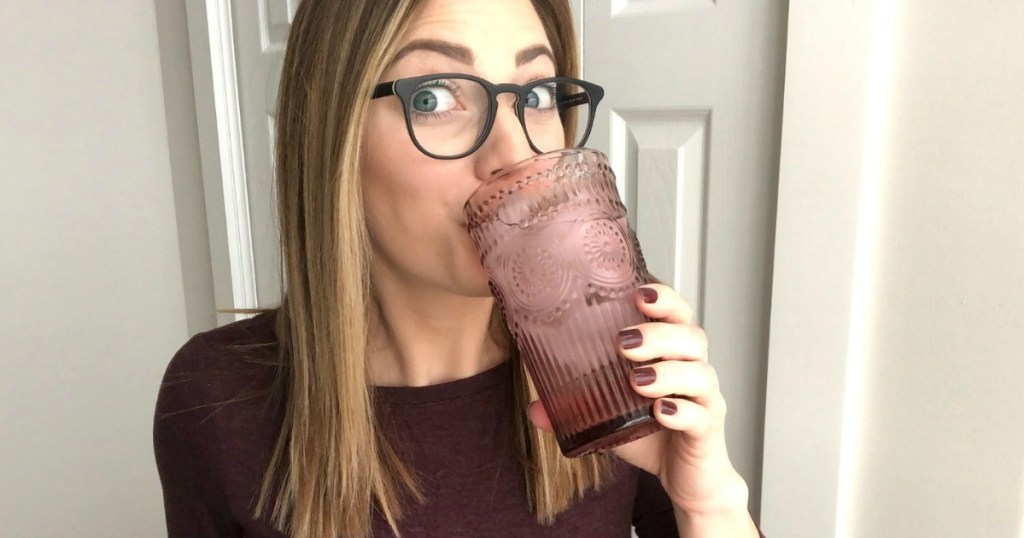 woman drinking water out of vintage drinking glass