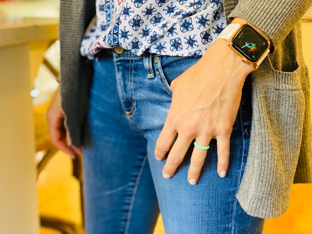 woman wearing silicone ring and apple watch with hand in pocket