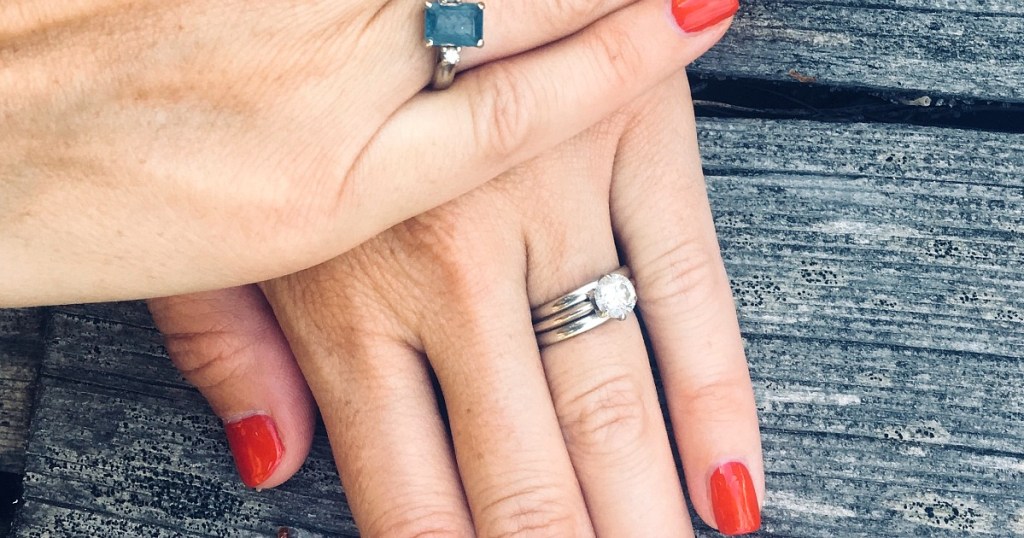 woman's hand with wedding band and diamond ring