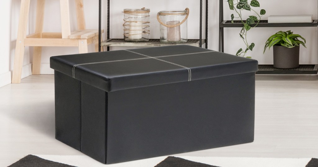 black faux leather storage ottoman in living room