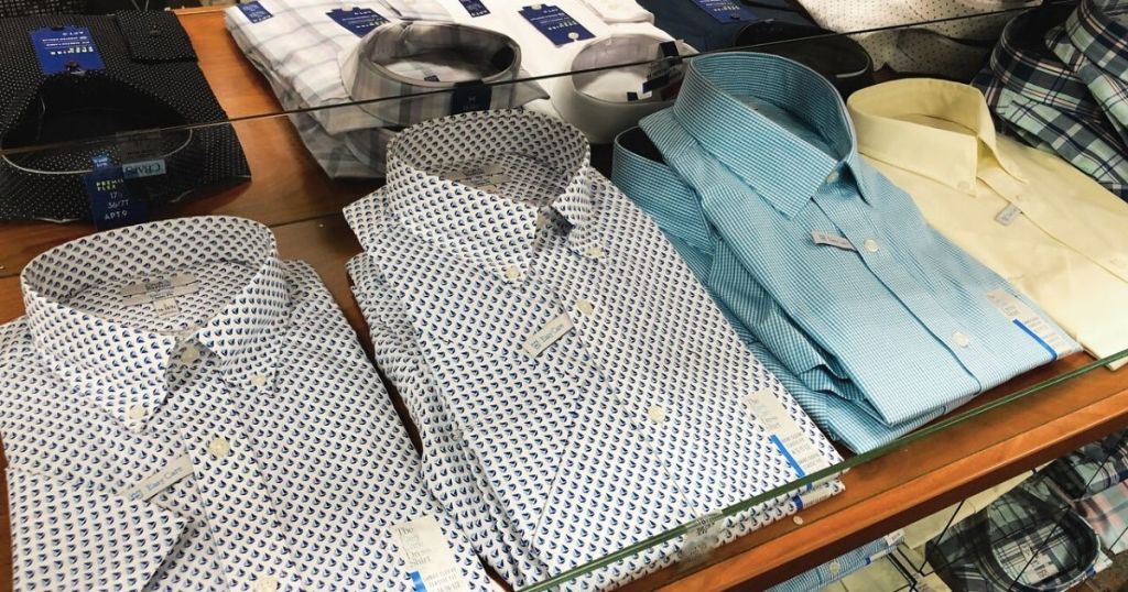 men's folded dress shirts at store on a display