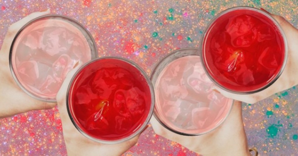 people holding pink and red drinks