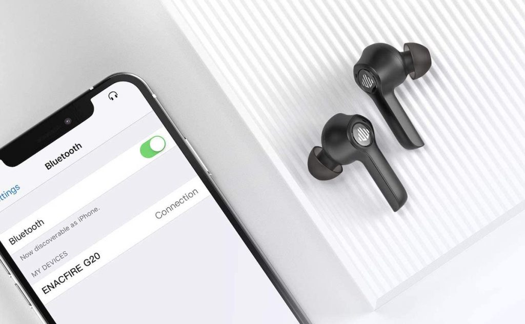 phone sitting next to earbuds