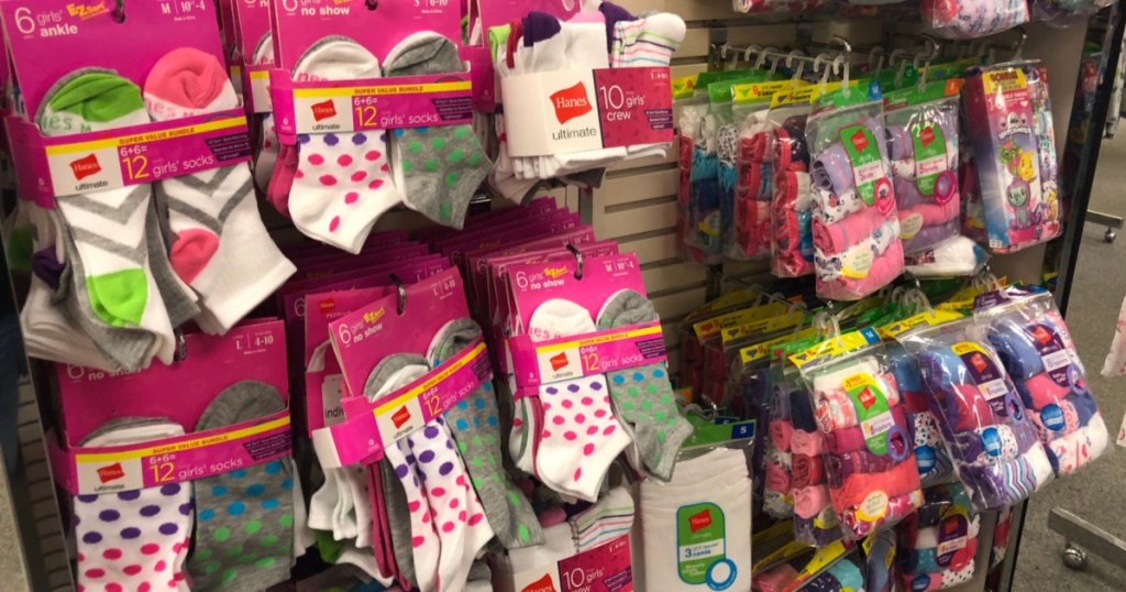 girl socks and underwear packs hanging on racks in store