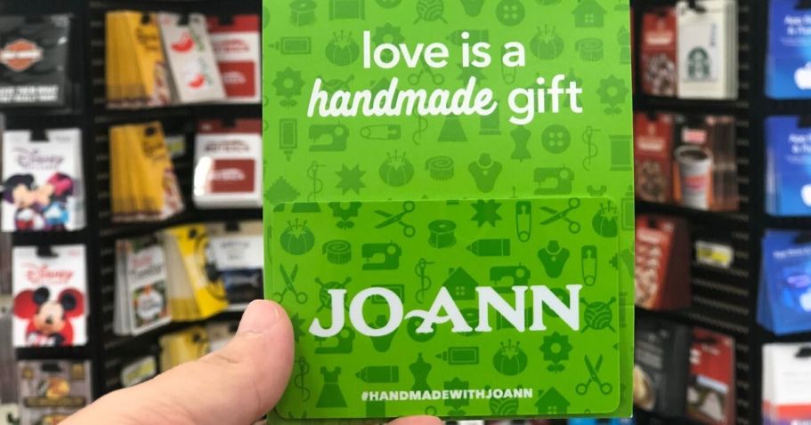 Woman's hand holding a gift card