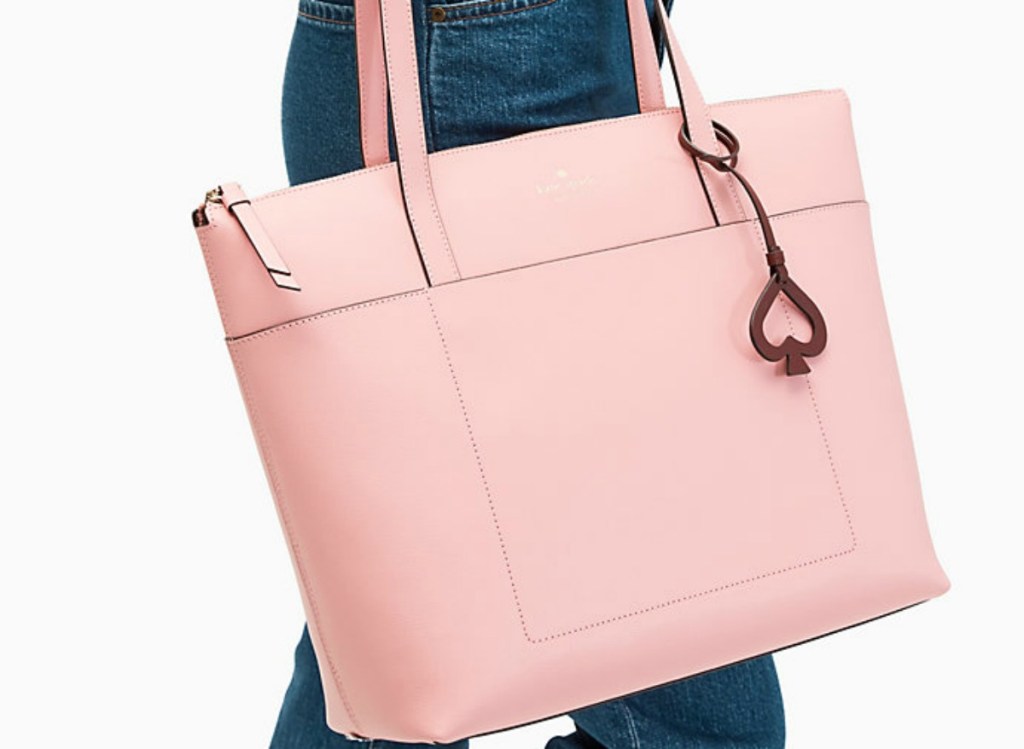 woman holding a large pink bag