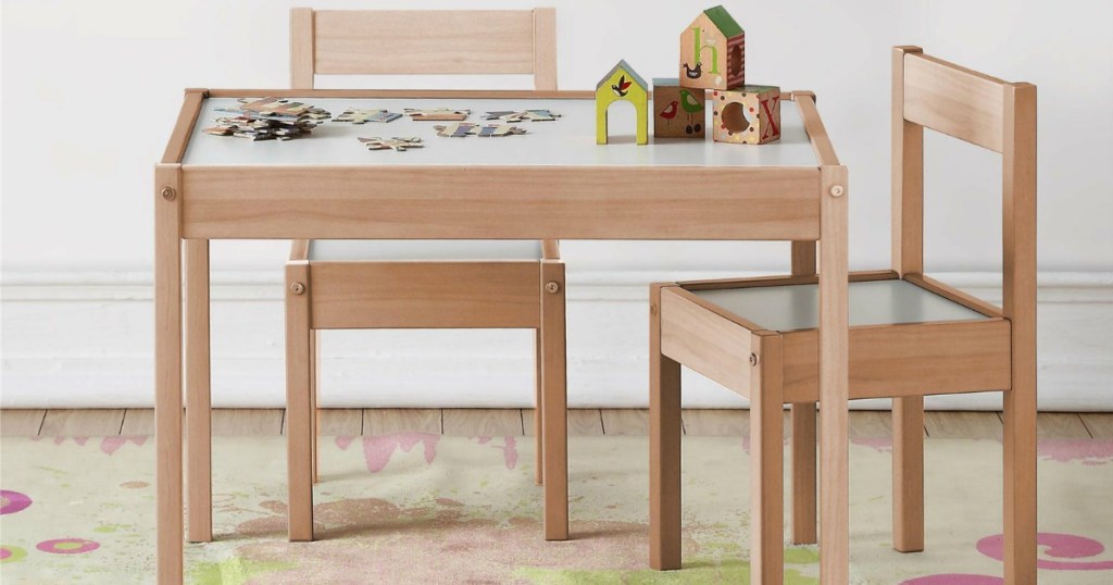 Light wooden table with kids sized chairs and puzzle on top