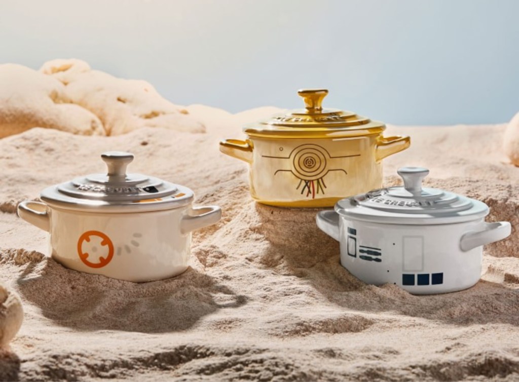 three Le Creuset Star Wars Mini Cocotte on sand like a planet