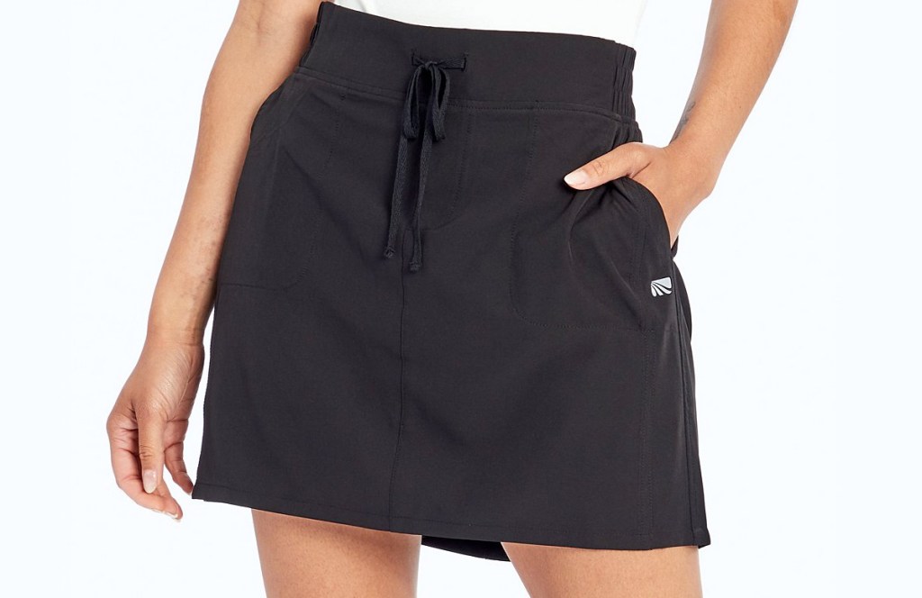 woman wearing black skort with pockets and tie at waist