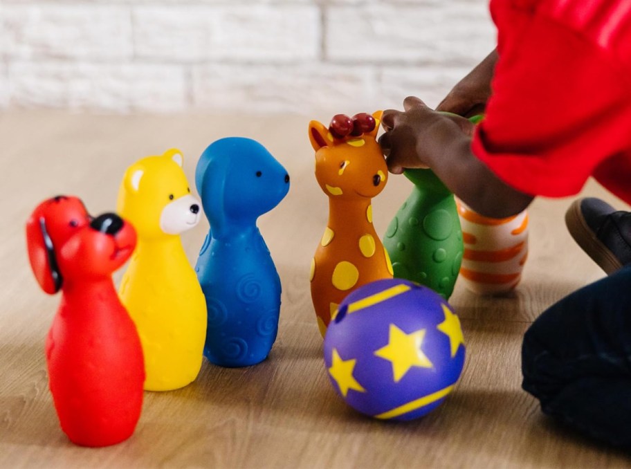 Boy playing with a Melissa and Doug indoor bowling set, one of the fun activities for kids to do indoors