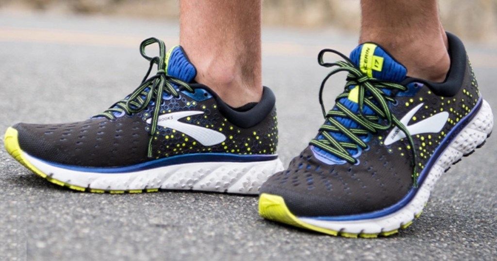 man in black and blue running shoe on pavement