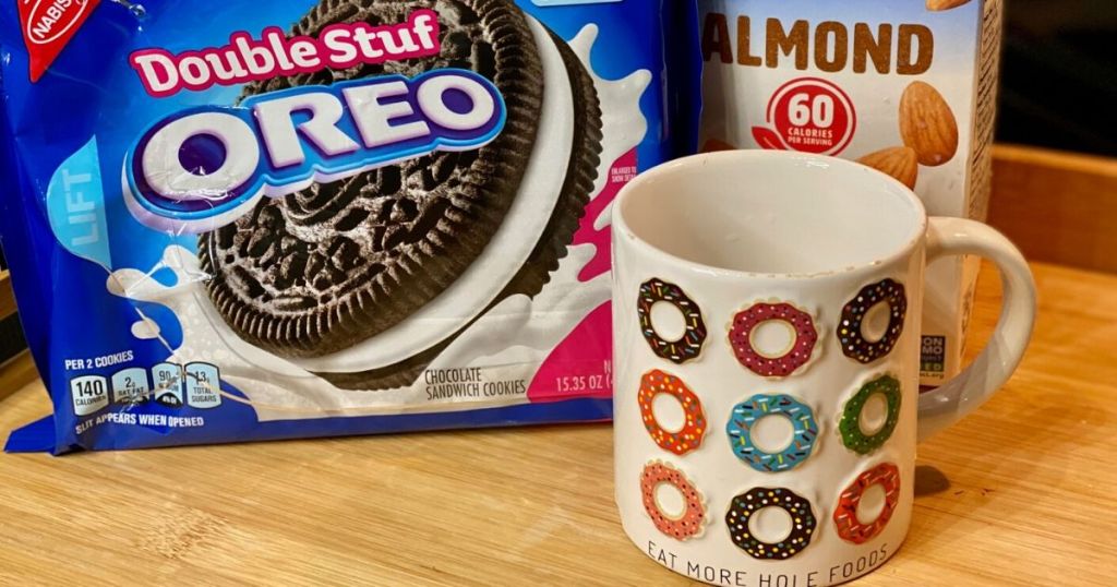 Package of oreos, milk and a mug on the counter