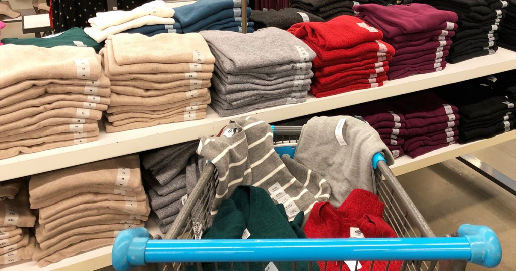a shopping cart full of sweaters at an old navy store