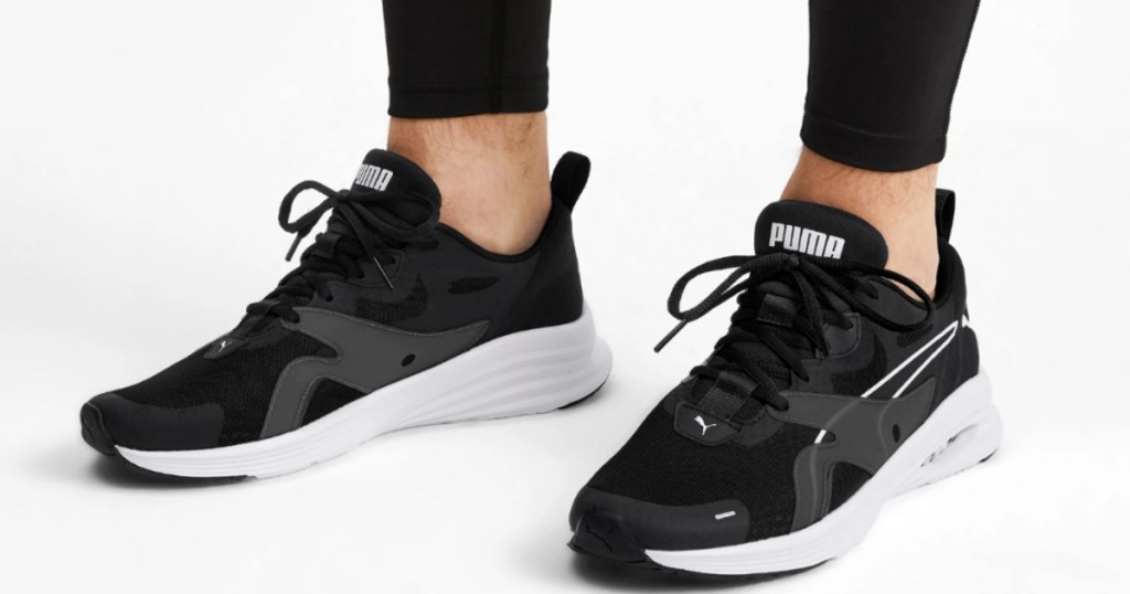 man wearing black and white running shoes