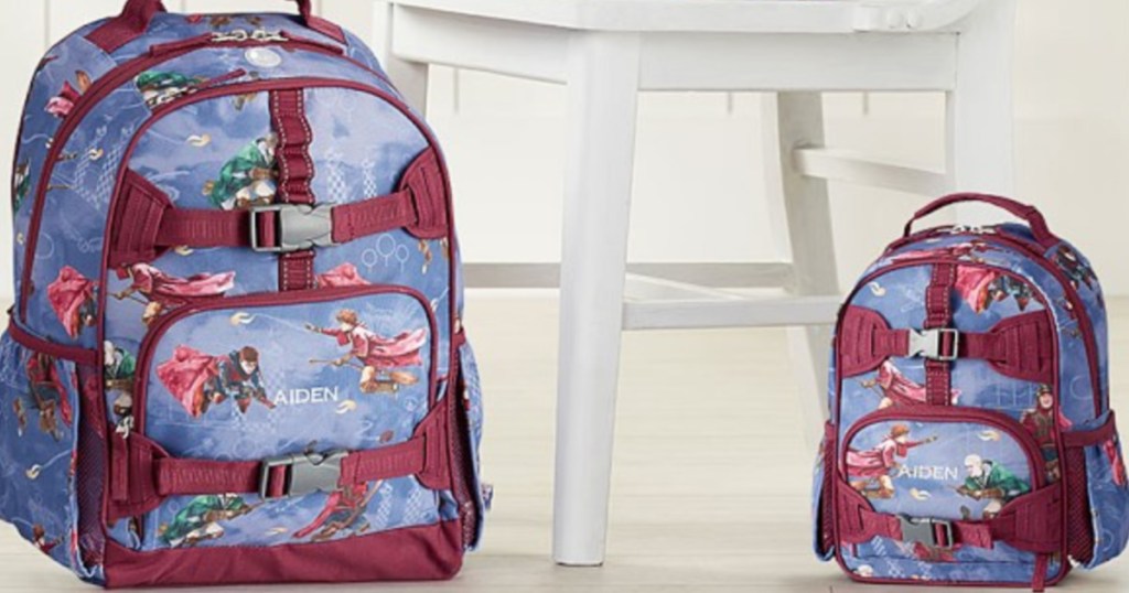 two kids harry potter backpacks sitting on the floor next to a white chair