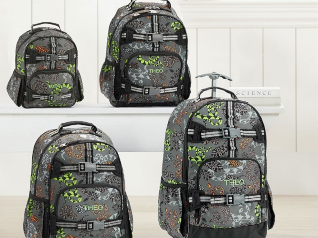 4 kids backpacks with snaks on them sitting in a group 