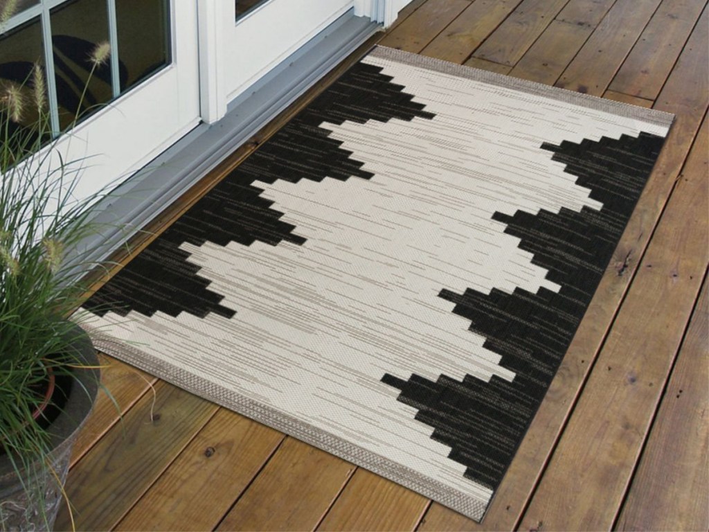 white and black outdoor area rug on deck