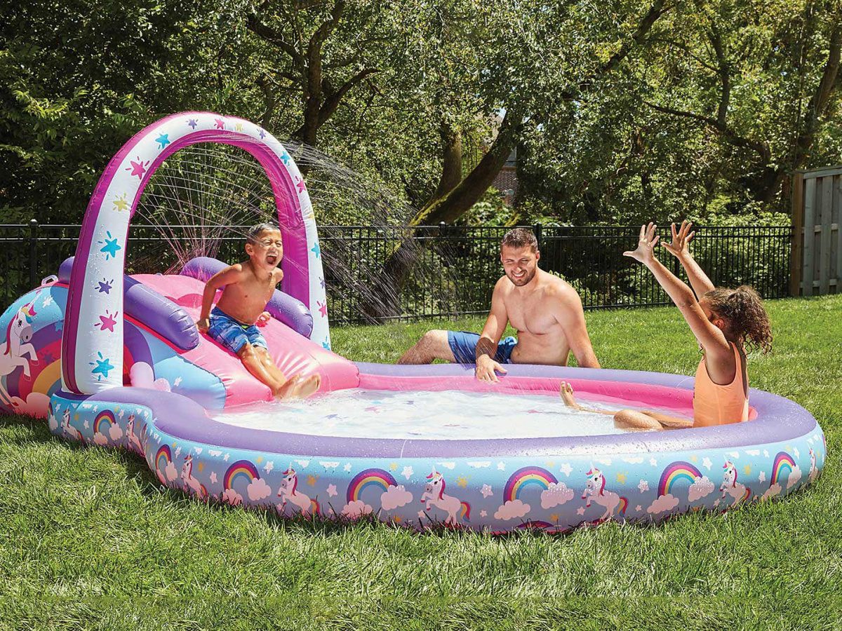 family sitting in a unicorn pool