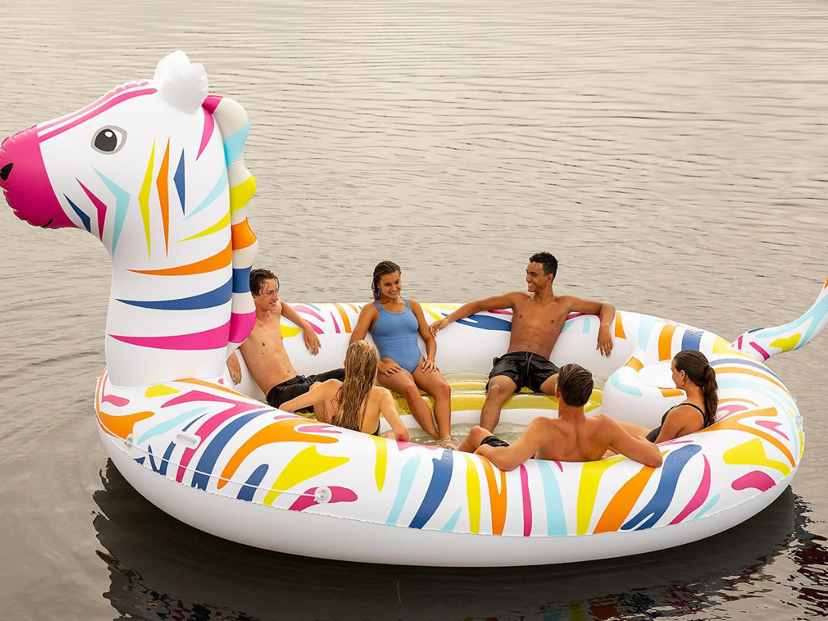 people sitting in giant zebra float 