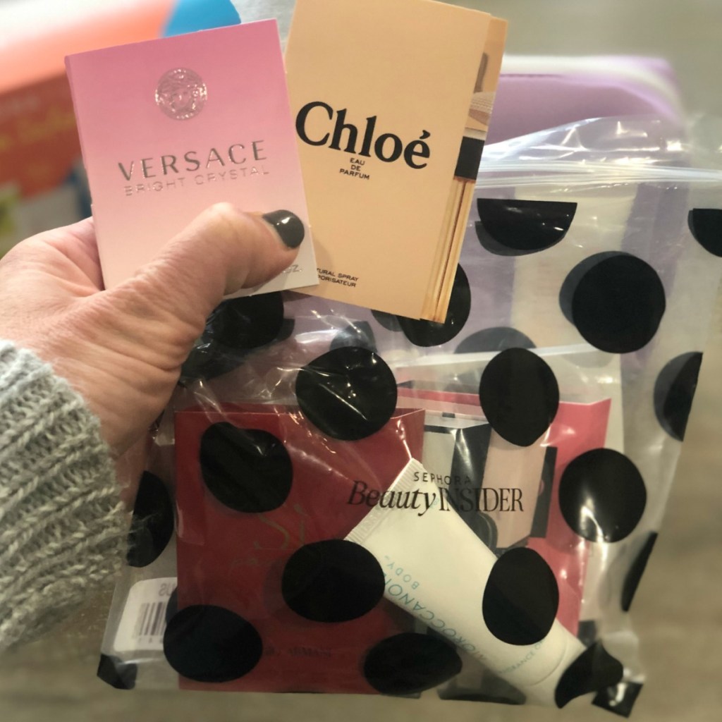 Woman holding free fragrance sample set