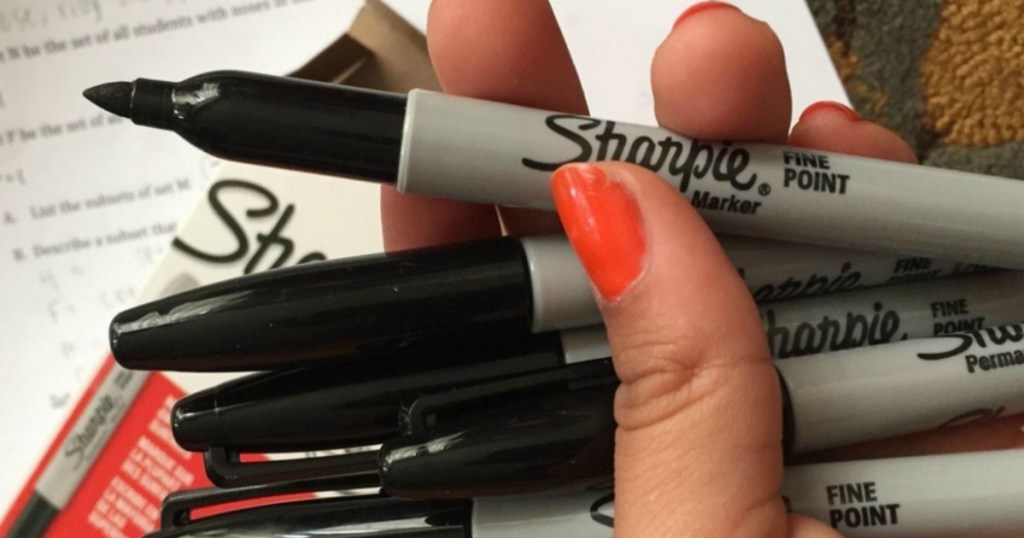 hand holding Sharpie markers