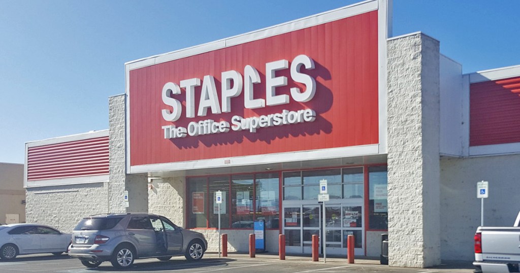staples store front with cars parked in front