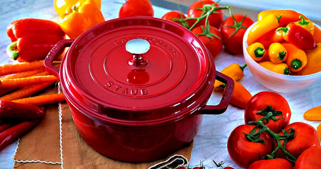 Staub 4-Quart Round Cocotte red on counter with vegetables