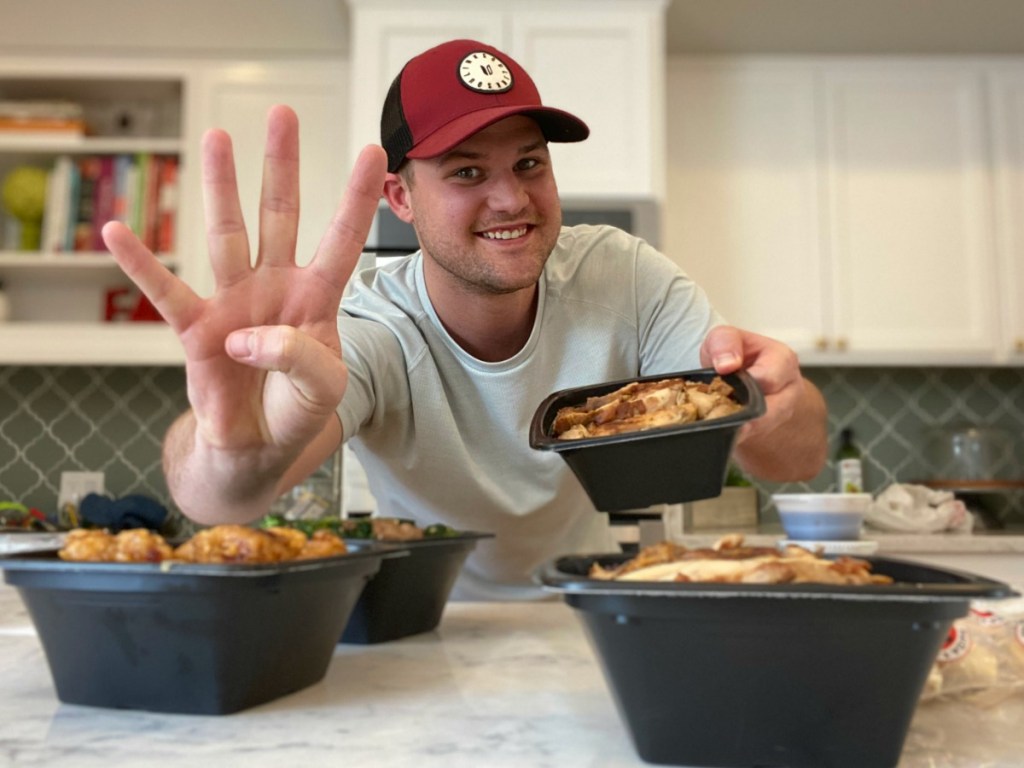 Man holding up 4 fingers and holding Panda Express bowl