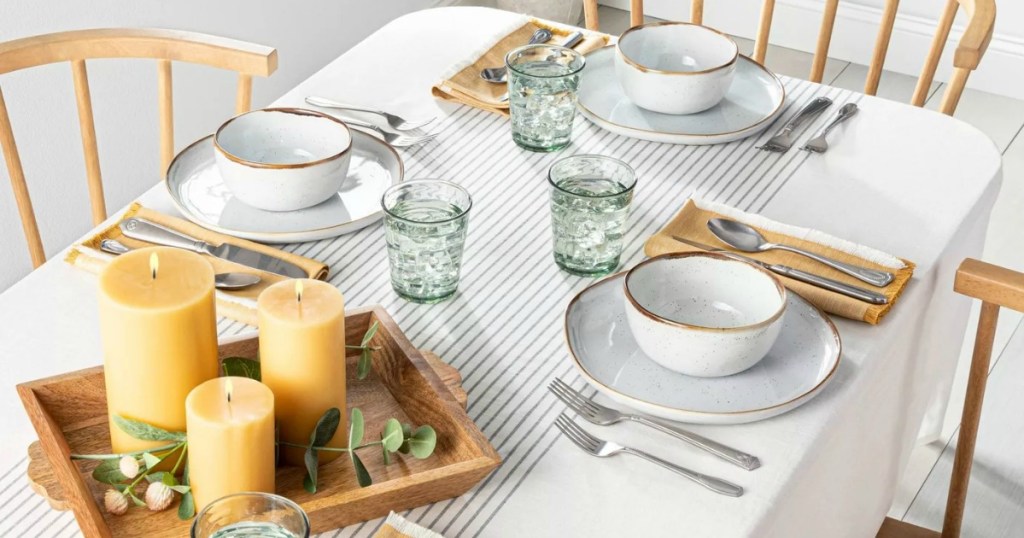 Large farmhouse table set up with striped tablecloth