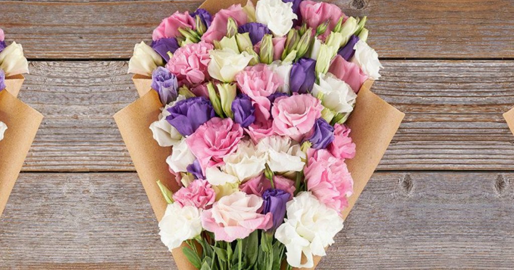 A farm-fresh arrangement of pink and purple lisianthus flowers.