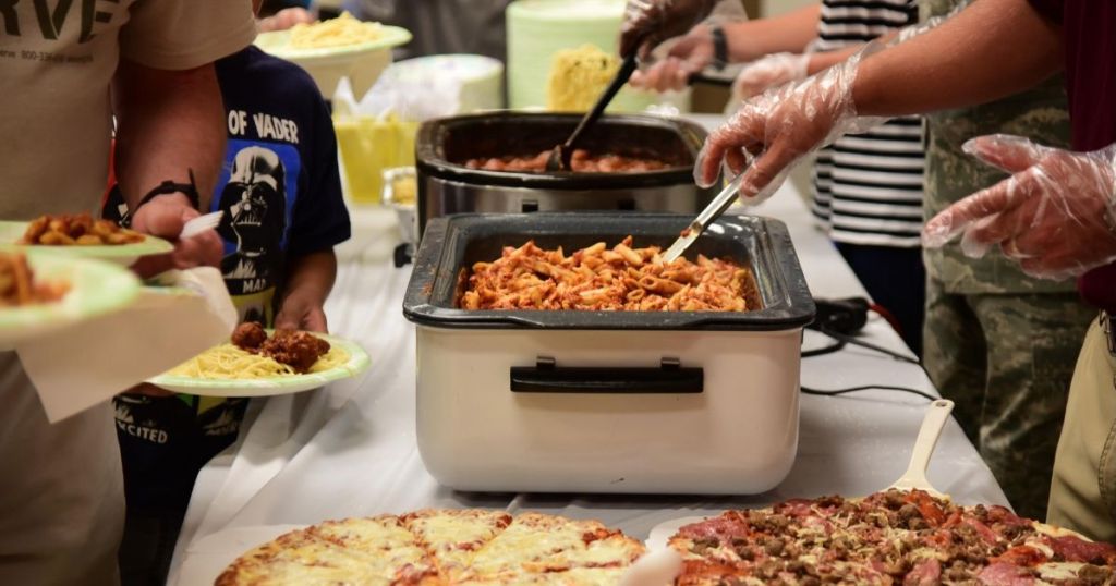 People getting food from community kitchen