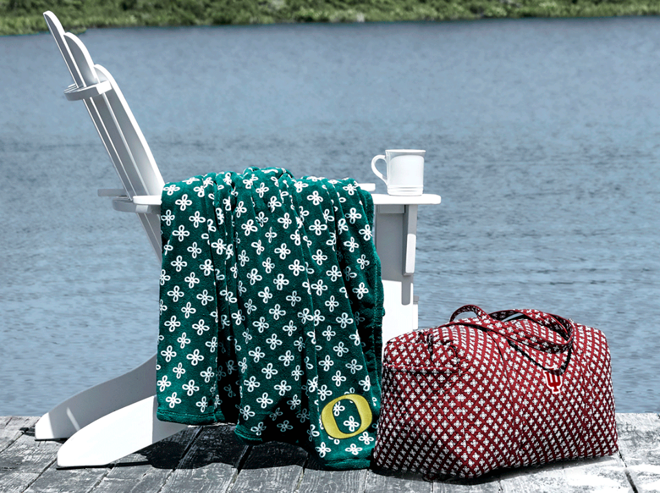 blanket on a chair with a duffel bag next to it