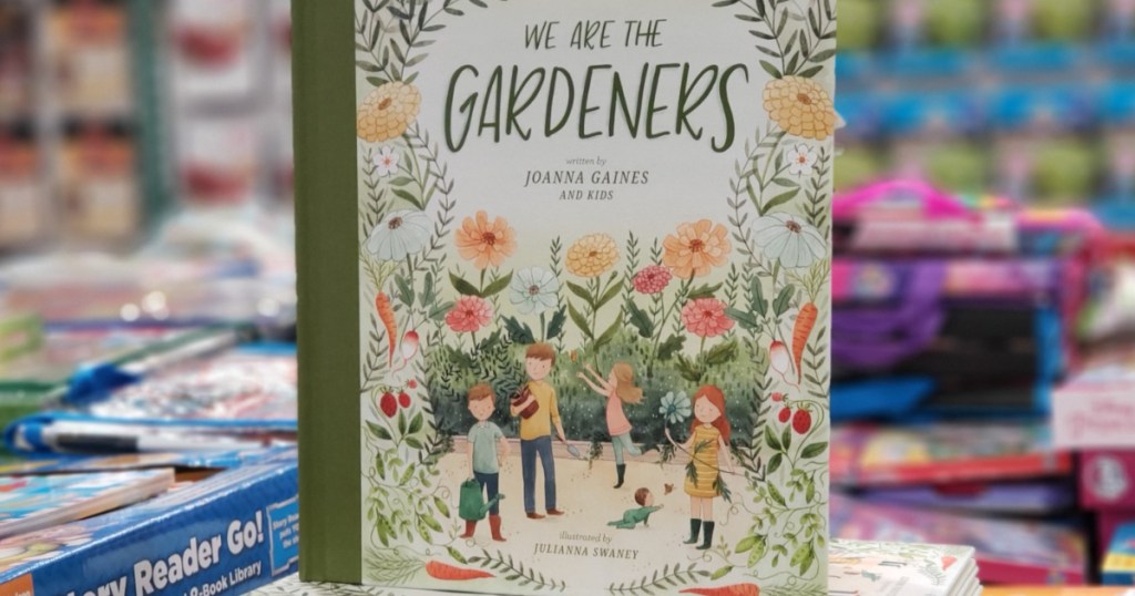 children's book standing on stack of books in store