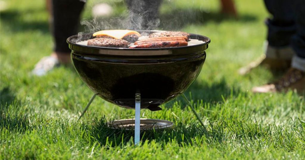 Weber Smokey Joe on grass with food on the grill